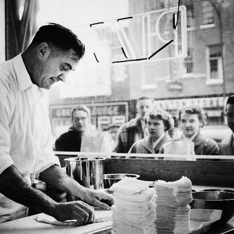 Making Sammy's Pizza while locals watch